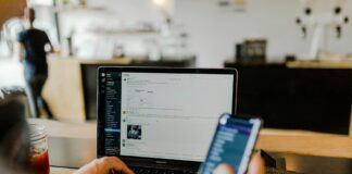 Hands with Phone and Laptop